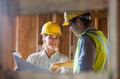 stock-photo-61515360-workers-talking-at-construction-site-reviewing-plans   